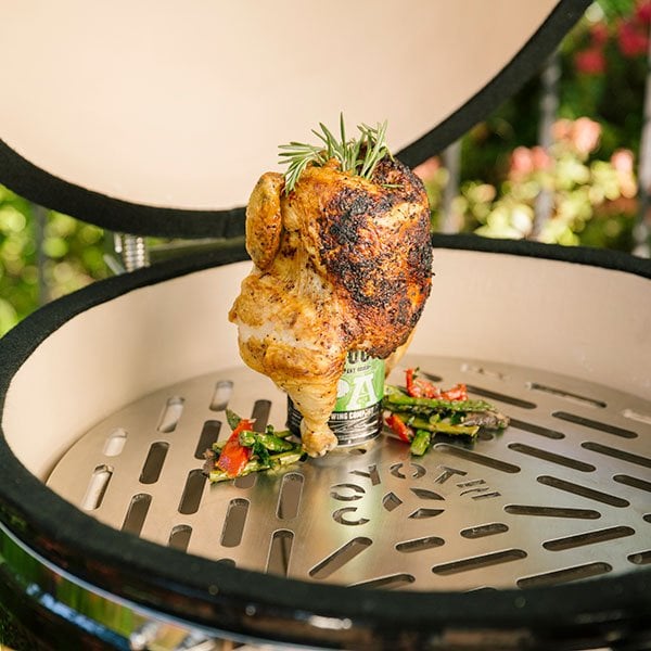 a chicken being cooked on a coyote asado