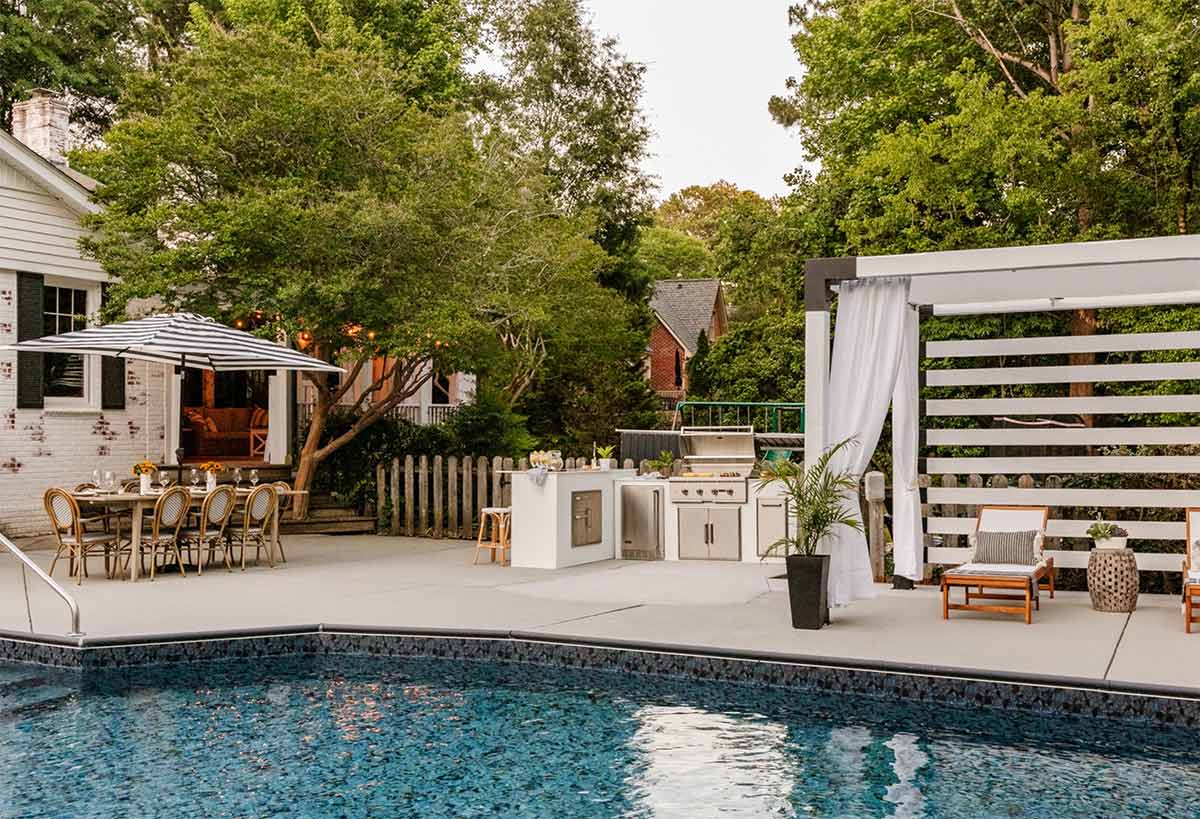 boho style outdoor living area with slatted pergola lounge area and a pool
