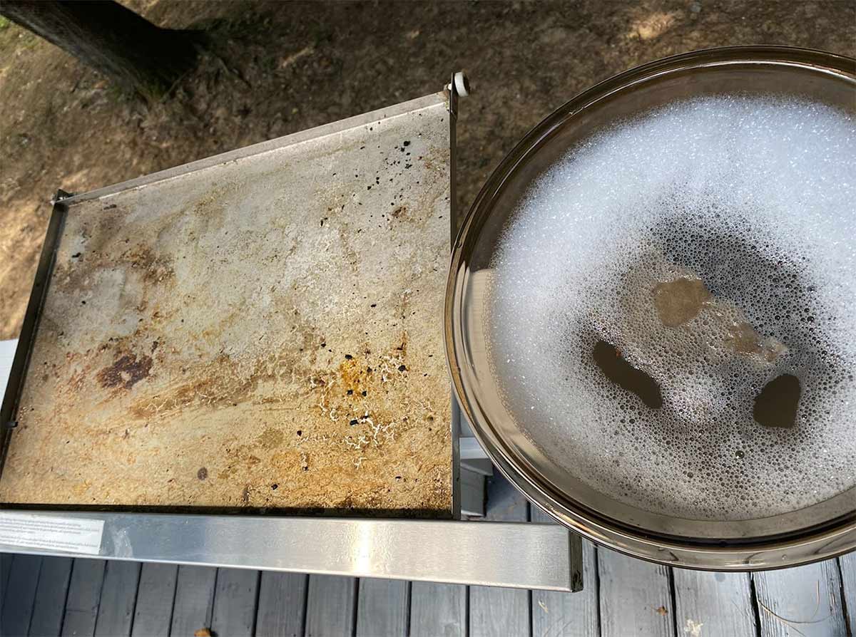 drip pan and bowl of warm soapy water