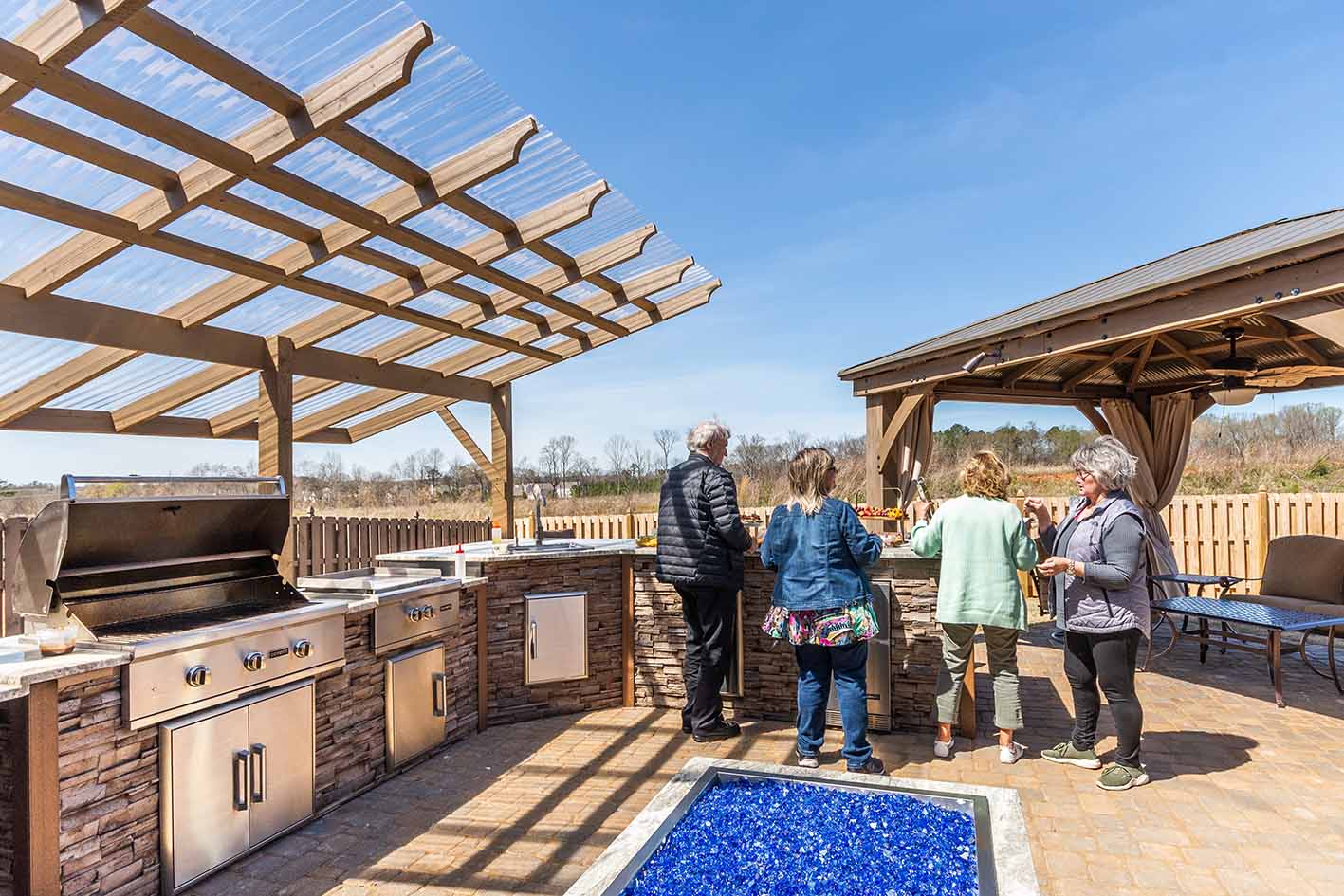 friends enjoying their outdoor kitchen after using free design tool software to create it