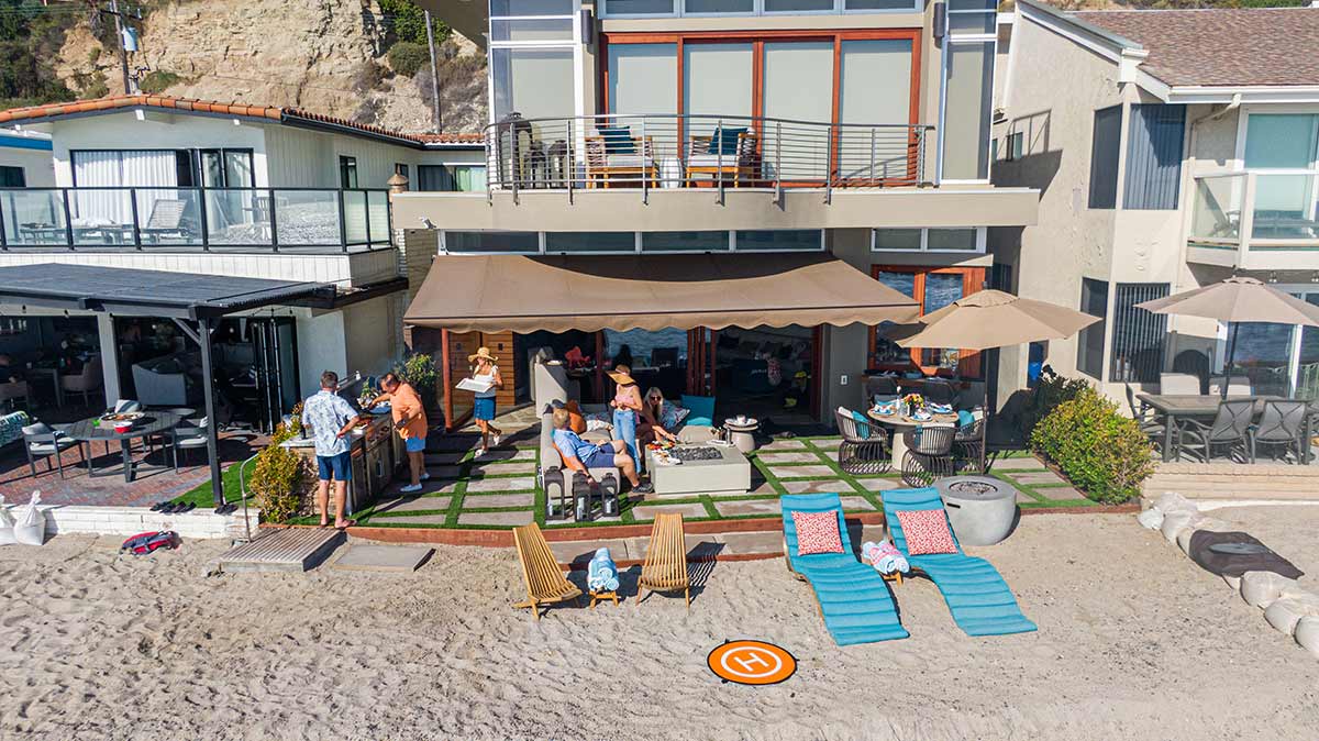 indoor outdoor living area with outdoor kitchen on beach