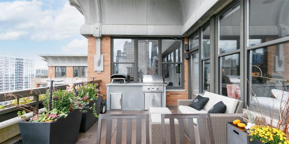linear grill island on balcony with planters
