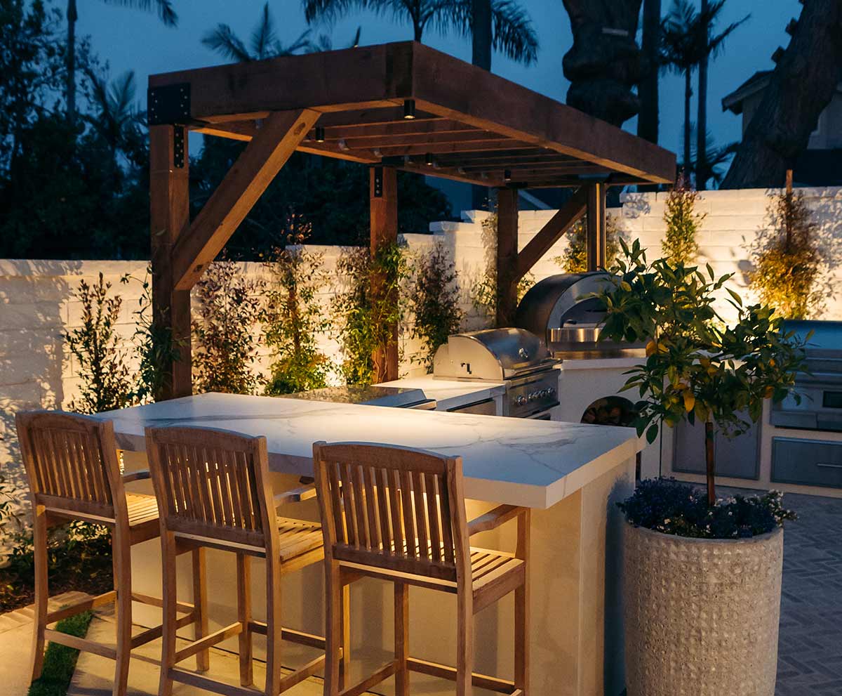mike pyles outdoor kitchen lit up in evening
