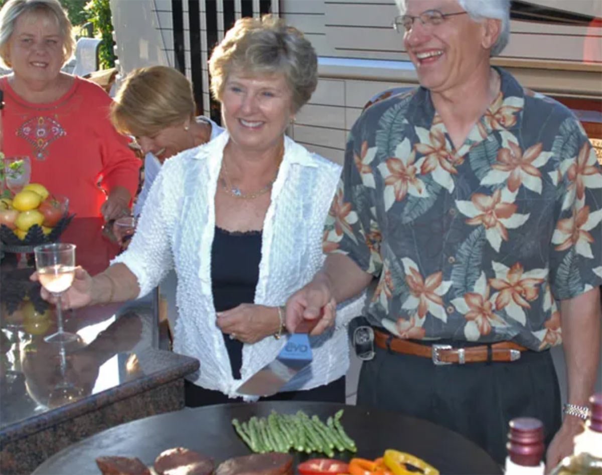 people standing by their evo flat top grill